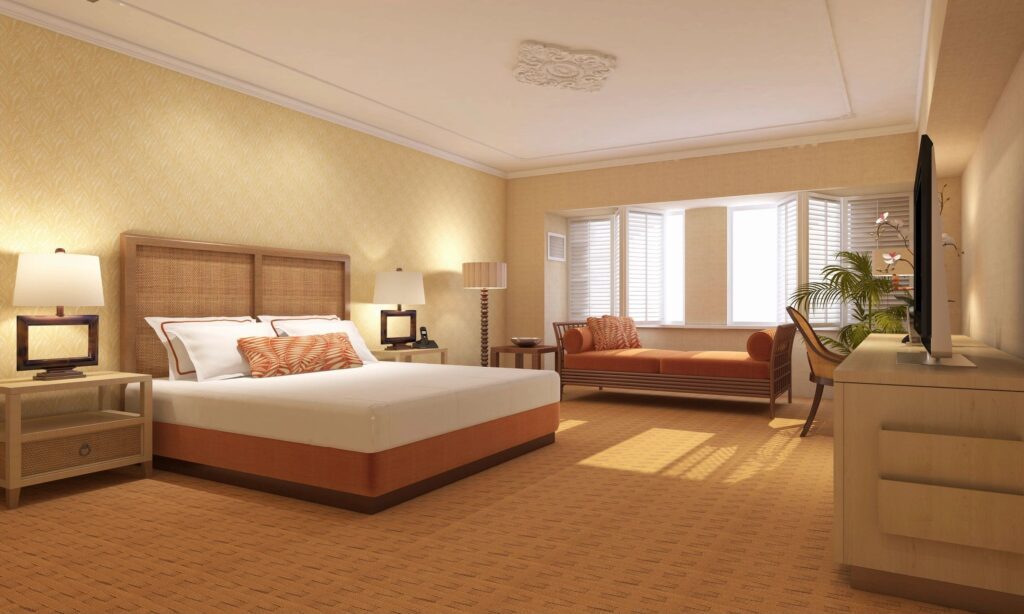 A bedroom with a bed, couch and chair.